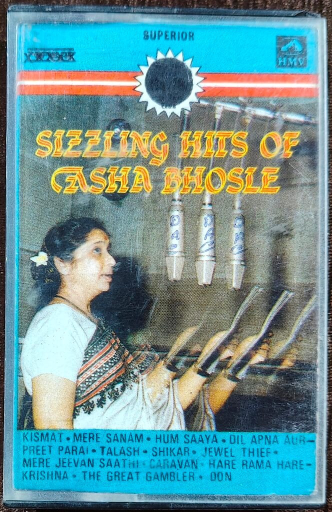 Asha Bhosle – Sizzling Hits of Asha Bhosle (1985) Hindi OST Compilation Album Pre-Owned HMV-Superior Audio Cassette